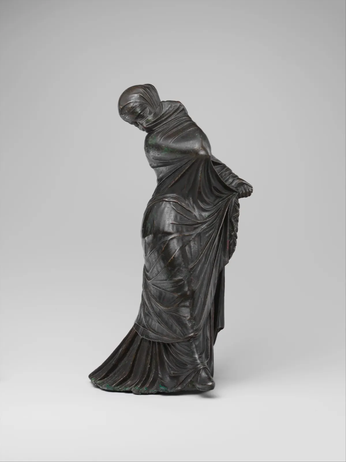 Bronze statuette of a veiled and masked dancer